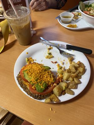 vegan avocado toast, home fries, and a iced hazelnut with almond milk   at The Speckled Egg Cafe in Fort Myers