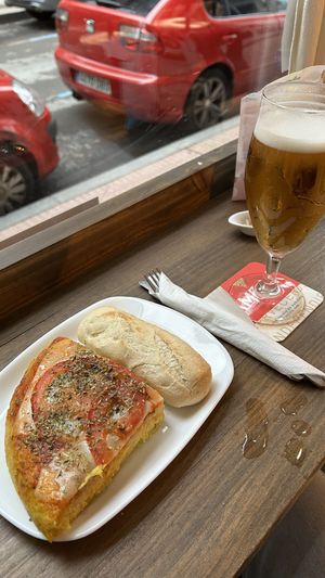 Ración de tortilla napolitana, la sirven con una barrita de pan    at Pasiones Bar  in Gijon