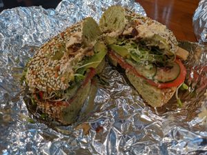 Breakfast specialty veggie sandwich with hummus and blue oyster mushrooms on pesto spinach everything bagel at Tahoe Bagel in South Lake Tahoe
