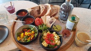 Vegan lunch for two with soup, a shake, a salad, tofu egg salad, and bread with some spreads and things to put on it at Anne&Max in Apeldoorn