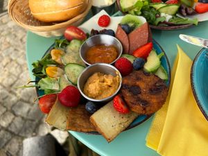 Vegan breakfast with fresh fruit, some salad, bread rolls, Tofu, vegan cheese, jam and a fryer Falafel. 👌  at Cafe MUSTI in Erfurt