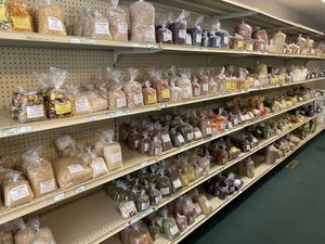 Aisle of bagged bulk items, each with labels featuring a Bible verse at Pure N Simple in Glens Falls