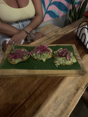 Tostones w smashed avo & lime pickled onion No feta  at Jungle SV in El Tunco