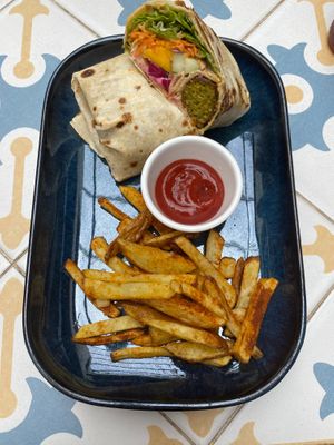 Falafel Tortillas Madeirense (hummus, alface, cenoura, pepino, cebola regional marinada, molho de maracujá, mango, amêndoas, couve e molho de iogurte de soja) - 11€  at Fala Fala in Funchal