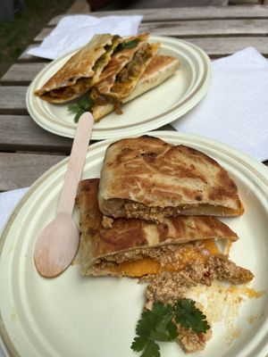 Spicy quesadilla and scrambled tofu with cheese in a naan bread  at Caked Coffee in Toronto