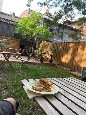 Amazing backyard patio like a little high park getaway  at Caked Coffee in Toronto