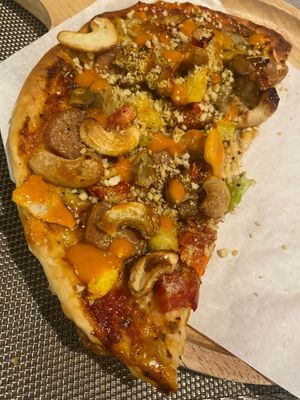 half of the meat pizza at Plant-erian in Krabi