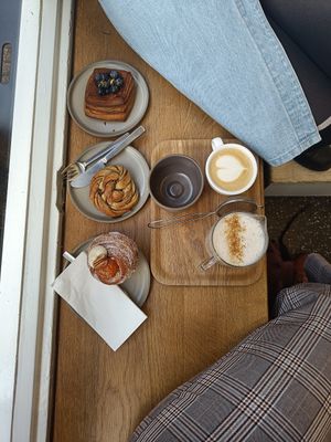 Pumpkin cruffin, cardamom bun, chocolate blueberry danish, chai latte with pea milk and a cappuccino. at Saint-Jean in Amsterdam