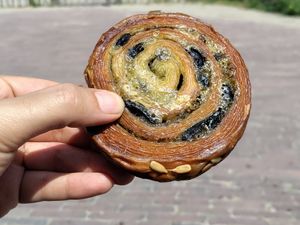 Savory pastry perfection: cheese, pesto, olives, sunflower seeds at Saint-Jean in Amsterdam