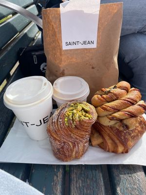 oatmilk latte and cappuccino, pistachio cruffin, pain au chocolat, cinnamon bun  at Saint-Jean in Amsterdam