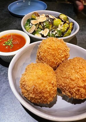 Saffron arancini and roasted brussels sprouts with almonds and tahini dressing. at Earthen  in Brooklyn