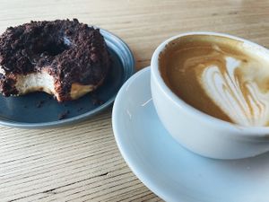 suzyQ dirty chocolate donut and a small cappuccino with oat milk at Little Victories Coffee Roasters in Ottawa