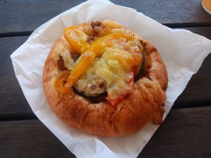 summer cheese curry pizza (heated up!) at Tokyo Vegan Bakes in Tokyo