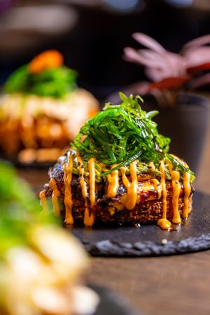 Sushi Pizza Vegan: Crunchy rice layer, avocado, sweet plantain, wakame, vegan spicy mayo & drizzle of vegan eel sauce. at Shibuya Sushi Art - Weston in Weston