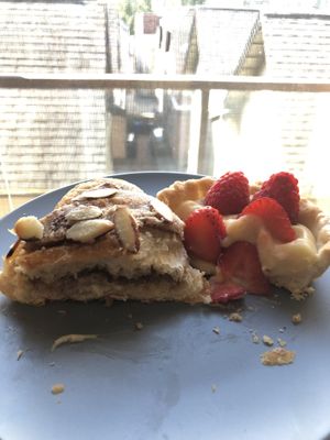 Half of almond croissant and half of a fruit tart  at Lazy Cow Bakery in Seattle