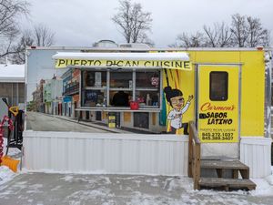 Cute Little Trailer and Space with Outside Tables and Fake Palm Trees at Carmen's Sabor Latino in Napanoch