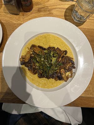 Blackened Mushrooms and Grits (blackened mushroom medley served over vegan cheddar grits;
garnished with pickled collard greens) at Maple Tree Inn in Homewood