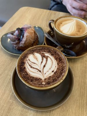 Oat latte, oat hot chocolate, and a berry Cinnamon Bun   at Fika in Bournemouth