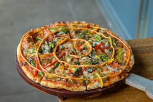Exotic Pizza : Thin Crust Pizza topped with Spinach, Roasted Bell Peppers, Broccoli, Onion, Tomato & Jalapenos at Quyu's Taproom in Jaipur