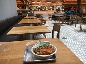 Vegan bowl, with view of food court at Teranga - Midtown in New York City