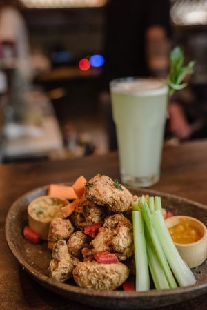 Puyu wings de coliflor. at Salvajes in Cusco