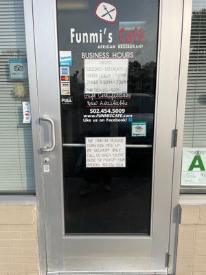 front door with sign indicating no dine-in at Funmi's Cafe in Louisville