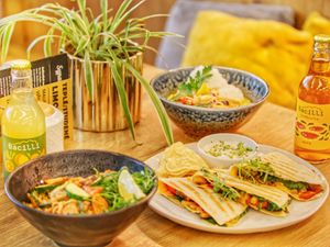 Selection of menu - quesadilla, asian noodles and curry at Mamafood in Prague