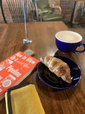 looks bourgeoisie but is working class af. oat milk latte & croissant   at Red Emma's Bookstore Coffeehouse in Baltimore