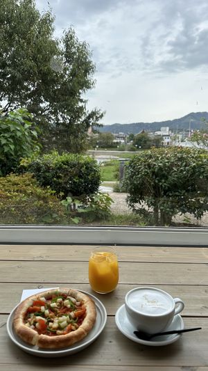 Tomato pizza, almond milk latte and orange juice  at Cafe Planet in Kyoto