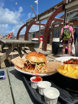 Exterior on wooden benches on the beach, all dog friendly at The Watering Hole in Perranporth