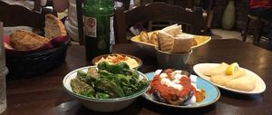 Padron peppers, bread, hummus, aubergine dish that started with B!  at The Old Yard Tapas Bar in Darlington