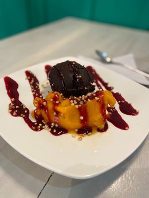 Dark machin, Filled with cocoa ganache lava, coconut milk and sweetened with coconut sugar, accompanied by frozen passion fruit and expanded quinoa rocks.   at Serendipia Encuentro in Salento