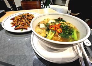 Yellow noodle with vegetarian wonton in mild soup. Stir-fried spicy spaghetti with Thai basil. at Talalaks  in Bangkok
