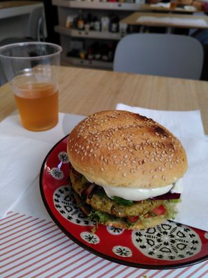 Burger Voltaire and glass of kombucha at Vegami in Como