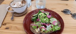 Avocado and hummus toast with pickled onions and cucumber. at Ananás Brunch in Sevilla