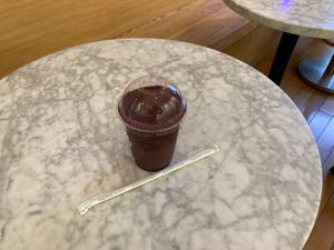 Acai smoothie; table inside shop. at Oakberry - Greenwich Village in New York City