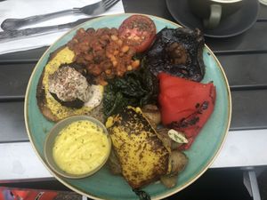 Incredible vegan breakfast: veg pakora, tahini, gunpowder, tarka hummus, vegan cheese, potatoes, greens, pepper, mushroom, tomato, house beans, porridge bread toast & vegan aioli  at CSONS in Shrewsbury