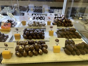 V stands for vegan. All the dates chocolate doesn’t contain milk and it is vegan   at Mirzam Chocolate Makers in Dubai