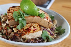 Vegan and GF Rice Noodle bowl with tofu, shiitake mushrooms, cabbage, cilantro, and cashew sauce at 7 Devils Waterfront Alehouse in Coos Bay