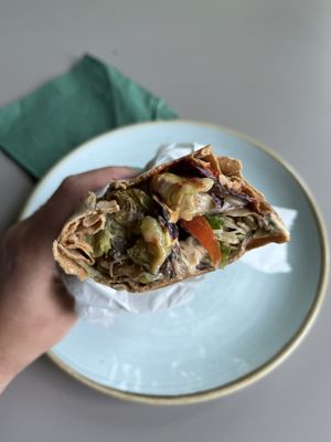 The vegan grill wrap is filled with cooked and raw veggies, a tahini and red sauce (not spicy )  at HIMMEL 8 in Berlin