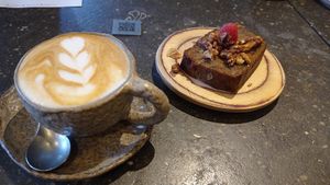 Almond latte and vegan banana bread at Honest Greens - Velázquez in Madrid