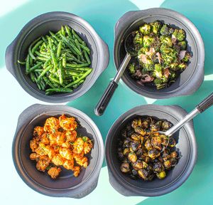 Hand-Cut Veggies: Garlicky Cilantro Green Beans, Sesame Ginger Broccoli, Buffalo Cauliflower, and Honey Sriracha Green Beans at Mahana Fresh in Charlotte