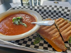 No, it doesn't come with a bite out it.  I was hungry.  Delicious!  Tomato Basil Soup with Grilled Cheese. at the hive vegan eatery in Houston