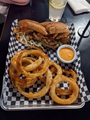 Oyster mushroom po'boy with Cajun spiced onion rings at the hive vegan eatery in Houston