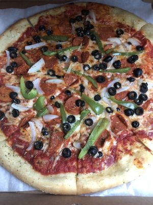 Vegan pizza with peppers, onions, olives, and vegan pepperoni  at Anika's Pizza in Moultonborough