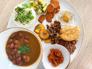 Vegan bandeja paisa, with lentil ground meat, sweet platains, vegan egg made with pumpkin and rice flour, vegan chorizo, arepa, hogao sauce, beans, shitaki and rice. at Gigi's Plant Based in Pereira