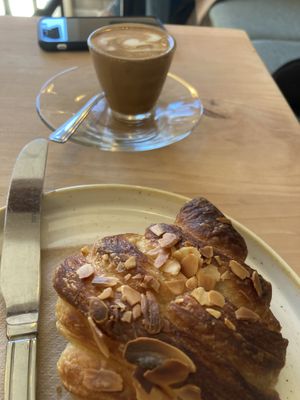 Almond croissant & soy cortado  at Fika+ in Chester