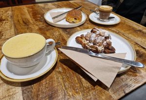 Turmeric latte and cortado with oat milk. Almond croissant and pain au chocolat. at Fika+ in Chester