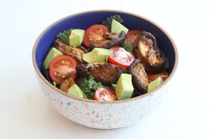 Paradeco signature mushroom bacon sitting on a fresh bed of St. Pete Brick Street Farms hydroponic Asian greens. Our mushroom bacon is marinated overnight.  at Paradeco Coffee Roasters in St Petersburg