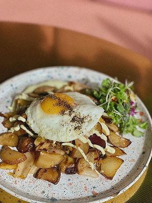 Kimchi-Potato Hash, First Roasted Fingerling Potatoes, red onion, Italian Olive oil and fresh roasted garlic. Vegan Scallion Aioli and micro greens.  at Paradeco Coffee Roasters in St Petersburg
